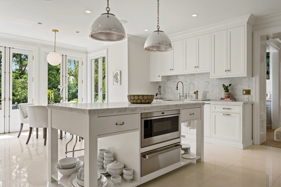 40 Woodley Road Winnetka, IL 60093 - Photo 23 of 60 a kitchen with stainless steel appliances kitchen island granite countertop a stove a sink and a refrigerator