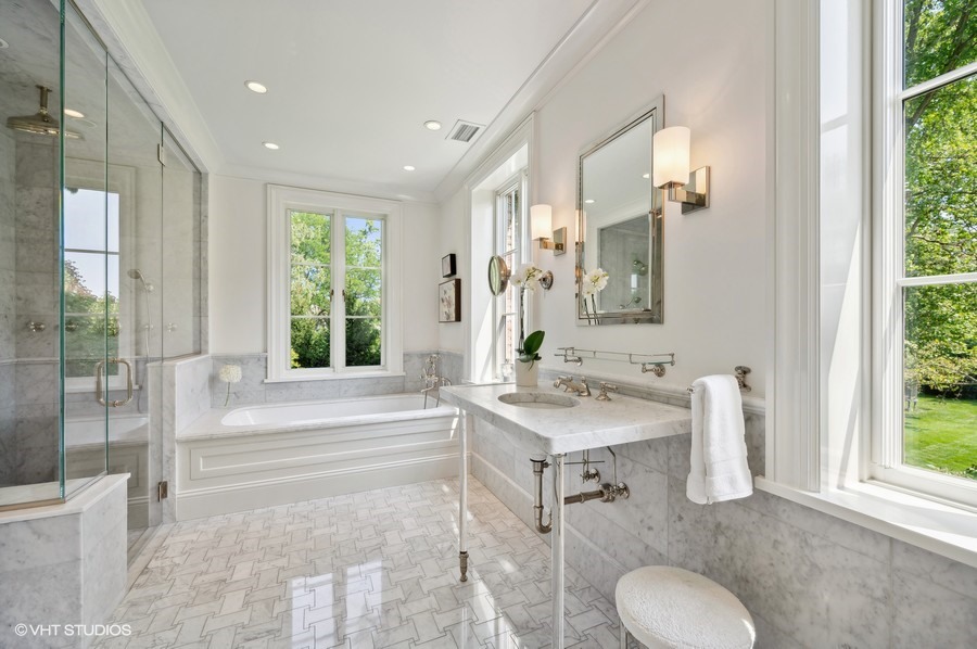 40 Woodley Road Winnetka, IL 60093 - Photo 40 of 60 a en suite bathroom with a granite countertop sink and a mirror