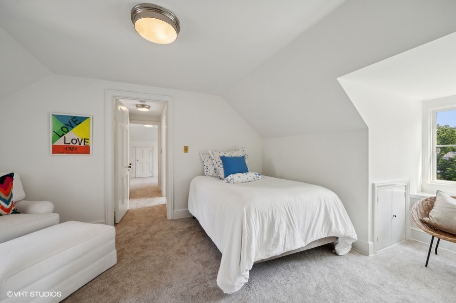 40 Woodley Road Winnetka, IL 60093 - Photo 45 of 60 a bedroom with a bed and a chandelier