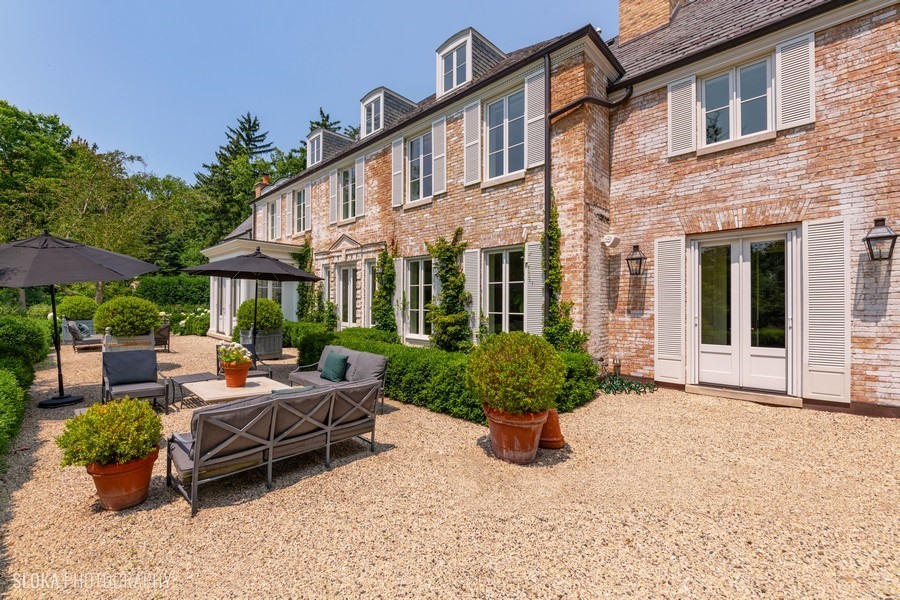 40 Woodley Road Winnetka, IL 60093 - Photo 46 of 60 a building outdoor space with patio furniture and potted plants