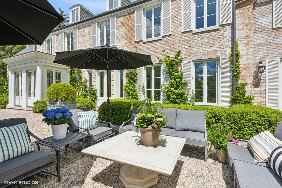 40 Woodley Road Winnetka, IL 60093 - Photo 48 of 60 a view of a house with backyard sitting area and garden