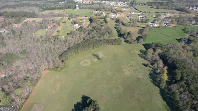 an aerial view of a house with a yard