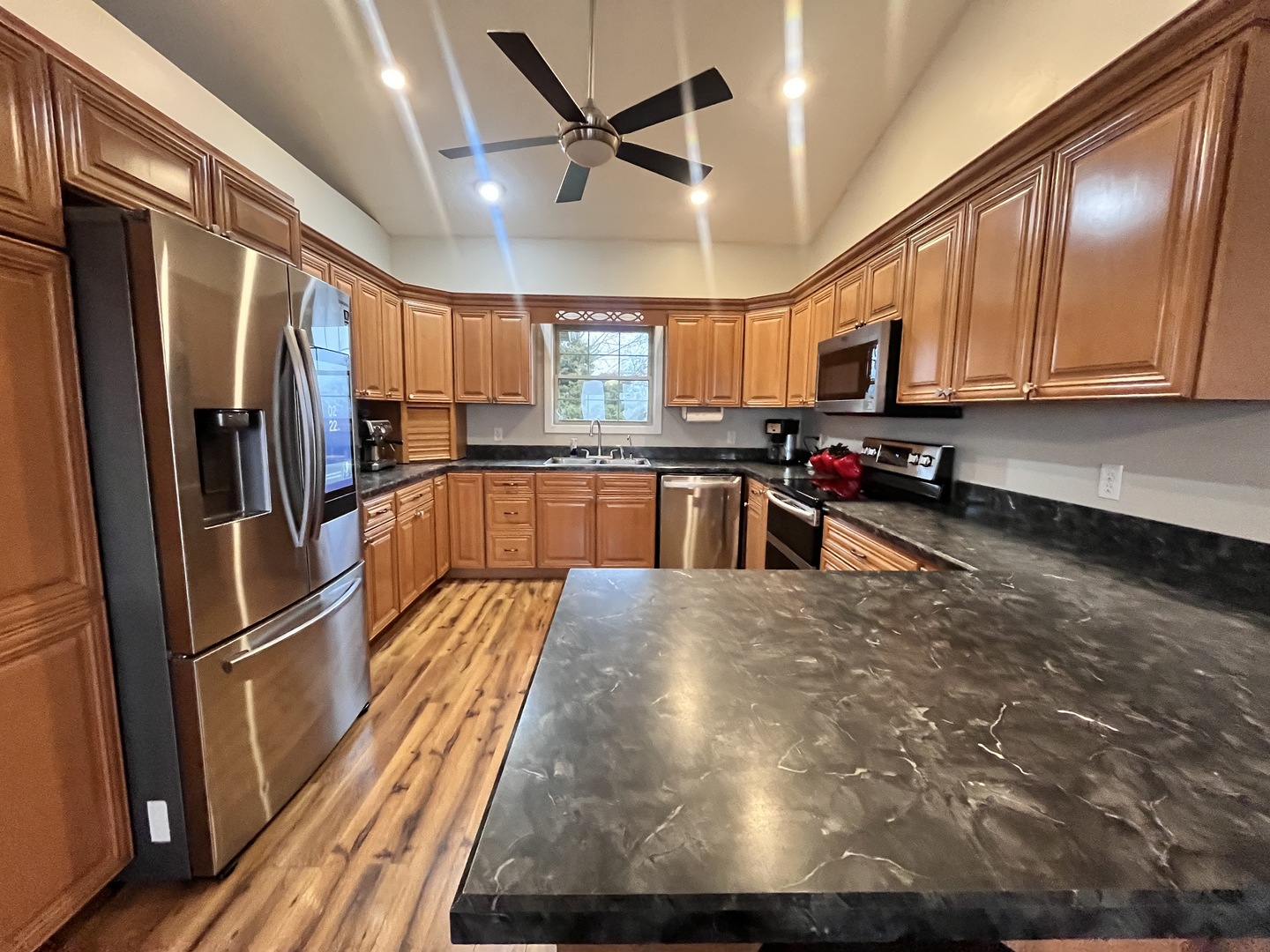 5488 Tick Ridge Road Grand Chain, IL 62941 - Photo 23 of 55 a kitchen with stainless steel appliances a refrigerator a sink a stove and cabinets
