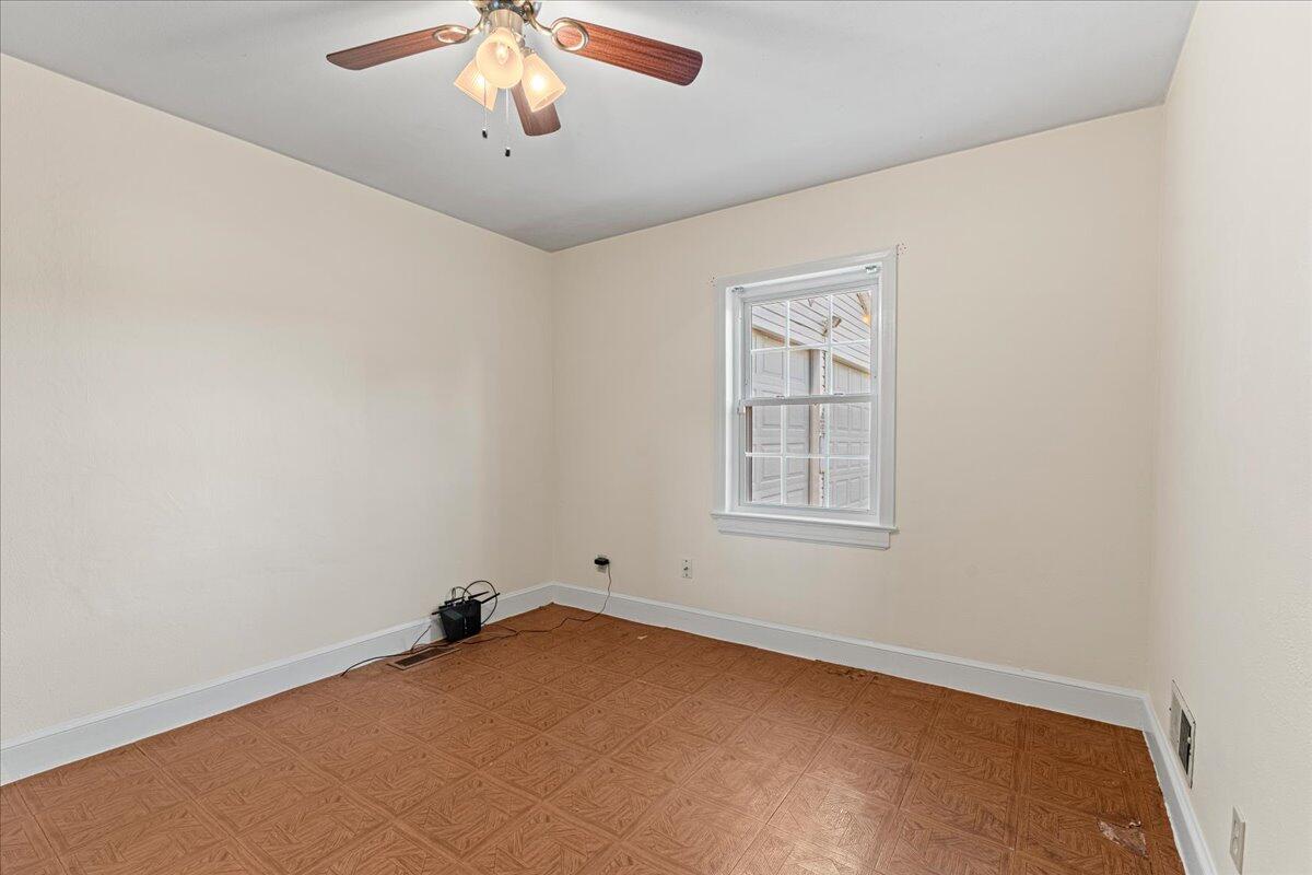 779 Catawba Road Daleville, VA 24083 - Photo 16 of 56 an empty room with a chandelier fan and windows