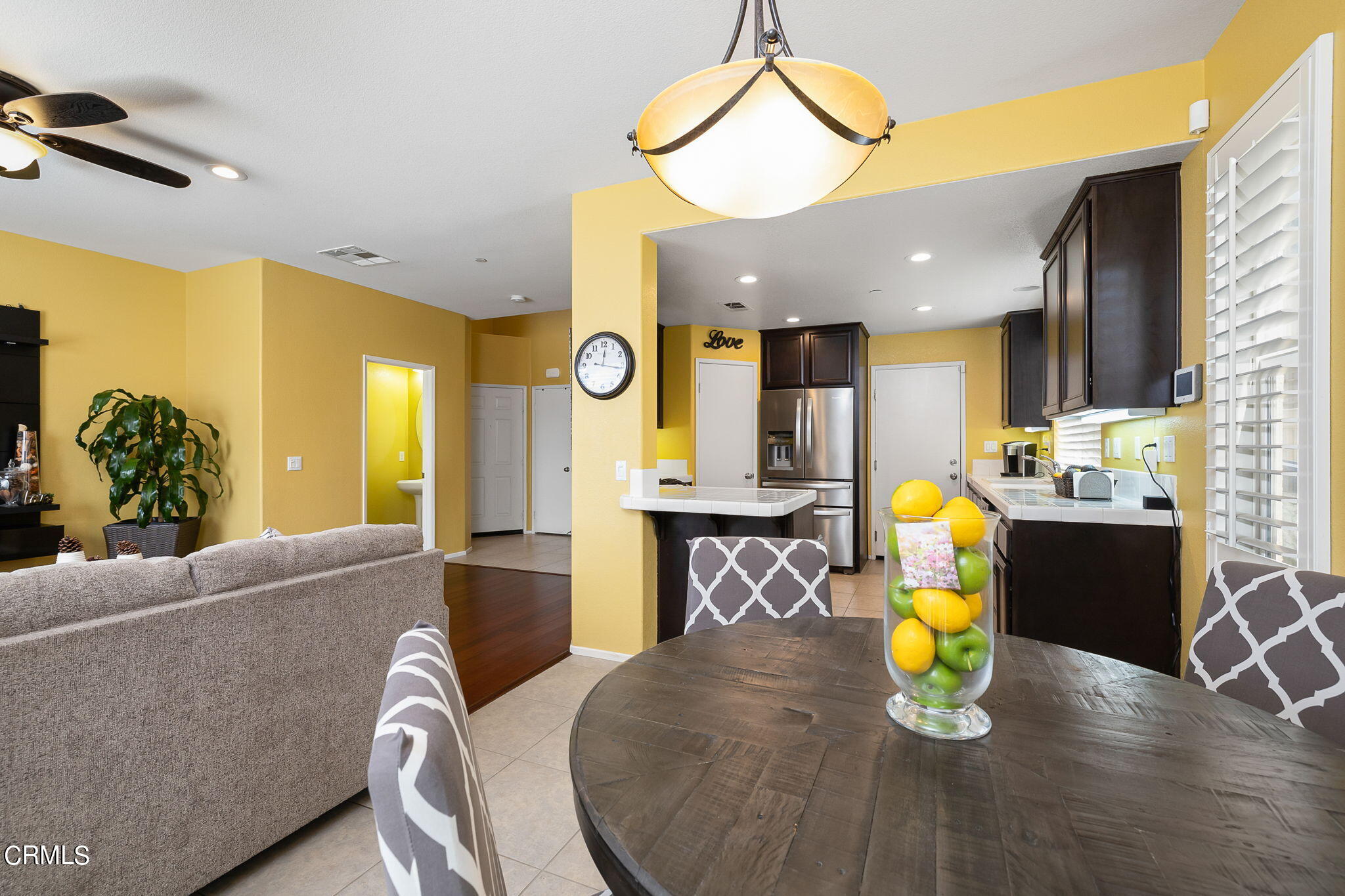 528 Field Street Oxnard, CA 93033 - Photo 23 of 24 a living room with dining table and a chandelier