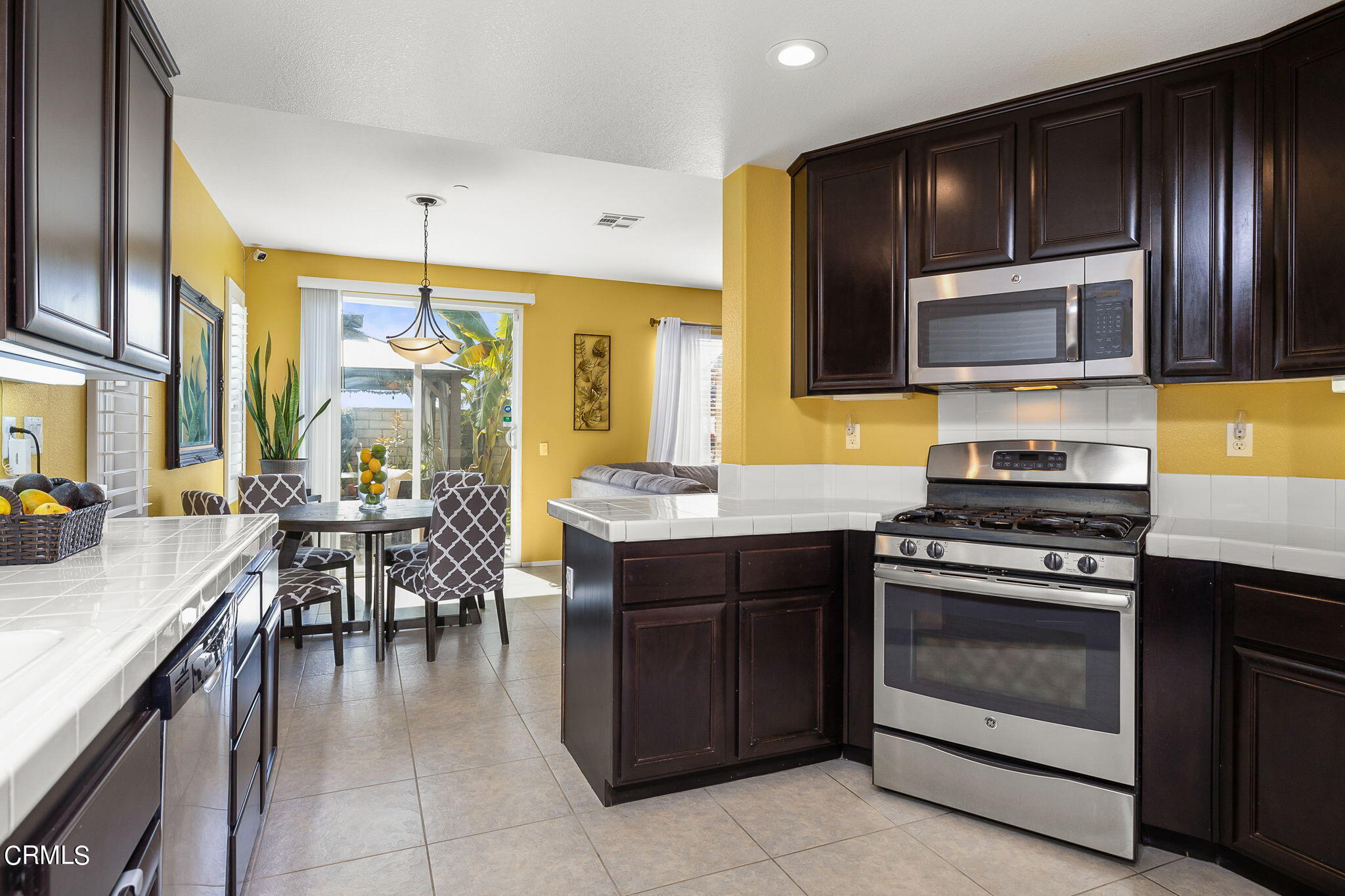 528 Field Street Oxnard, CA 93033 - Photo 5 of 24 a kitchen with a stove a sink and a microwave