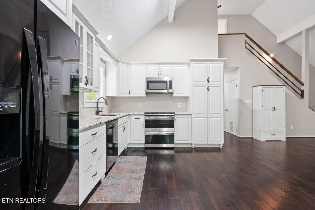 8908 Ellis Lane Powell, TN 37849 - Photo 11 of 37 a kitchen with stainless steel appliances a refrigerator sink and cabinets