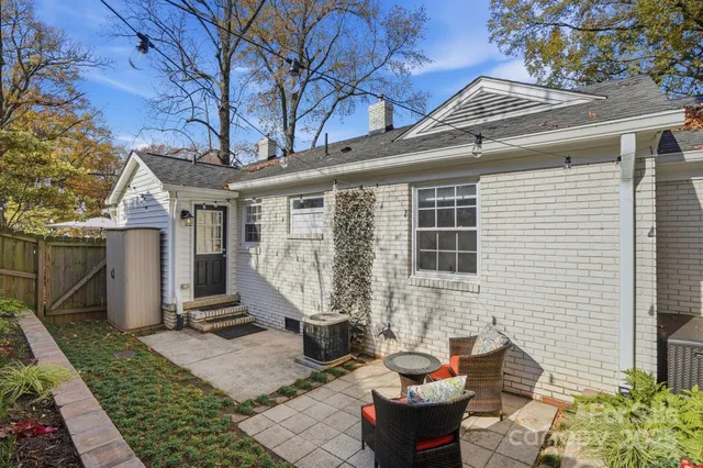 a view of a patio with couches table and chairs and potted plants