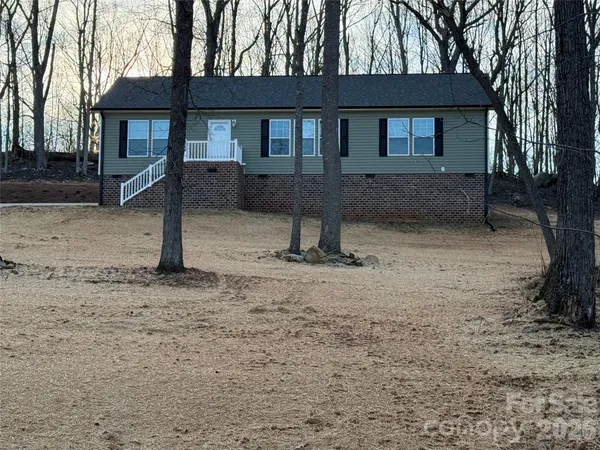 a house that has a tree in front of it