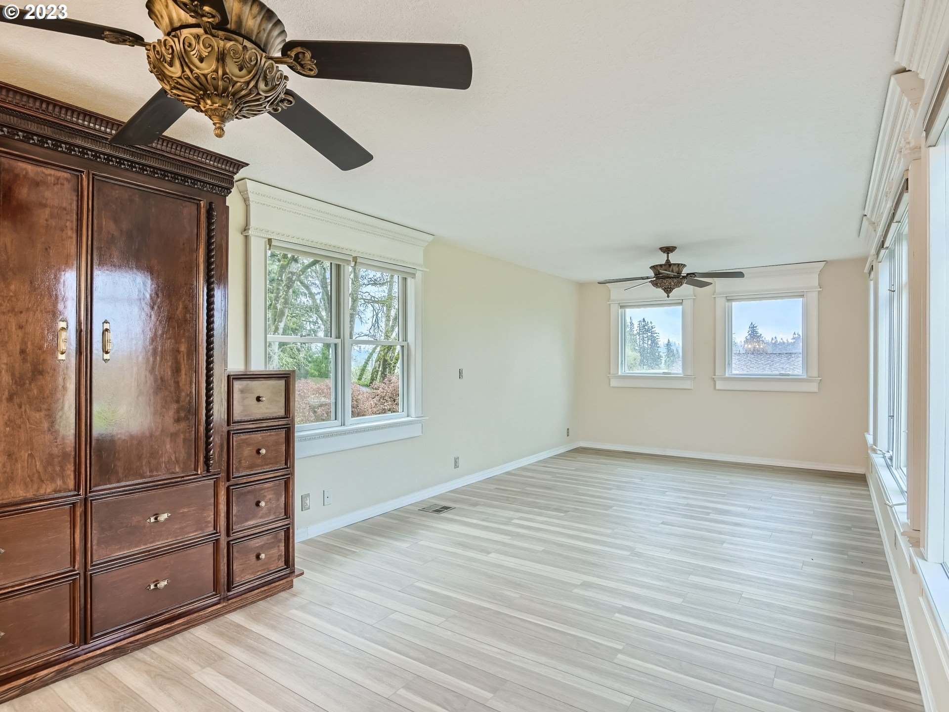 32062 South Barlow Road Canby, OR 97013 - Photo 21 of 33 a view of an empty room with a window and wooden floor