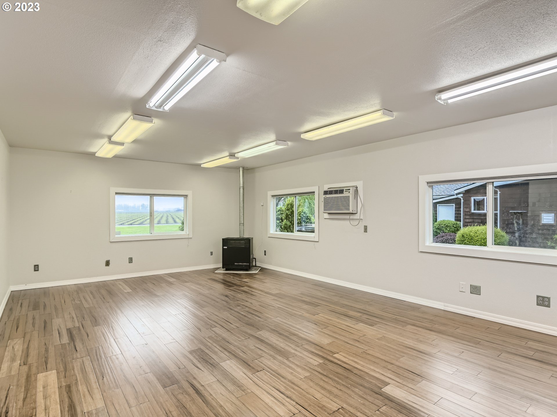 32062 South Barlow Road Canby, OR 97013 - Photo 30 of 33 an empty room with wooden floor and windows