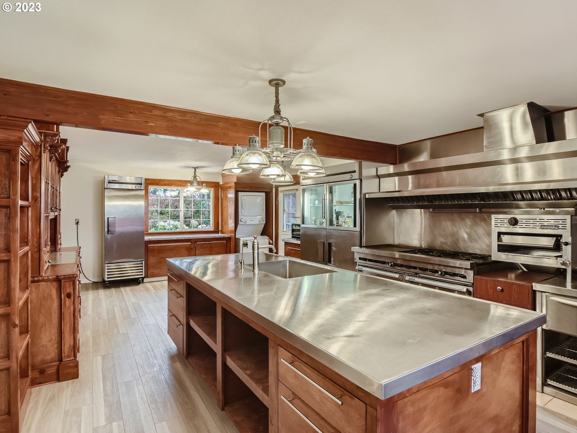 32062 South Barlow Road Canby, OR 97013 - Photo 8 of 33 a kitchen with stainless steel appliances a sink a stove and a wooden floors