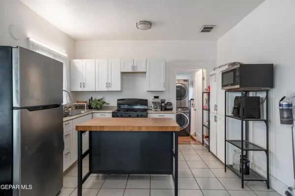 a kitchen with stainless steel appliances a refrigerator stove microwave and sink