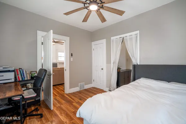 a bedroom with a bed and a chandelier