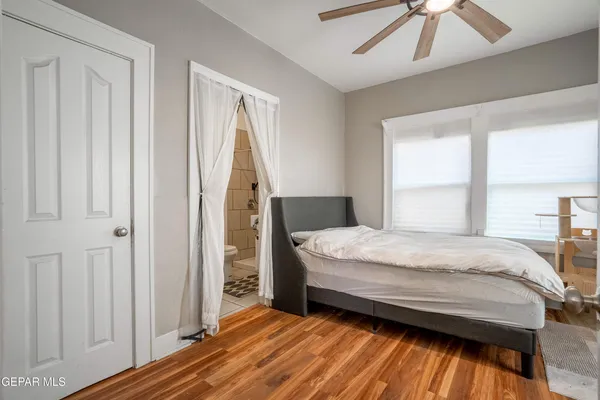 a bedroom with a bed next to a window