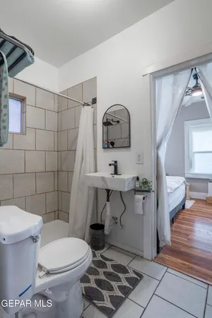 a bathroom with a toilet sink and mirror