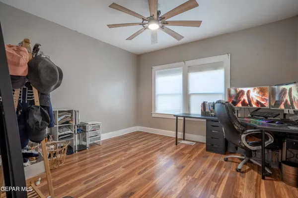 a view of a workspace with furniture and a window