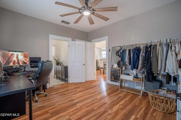 a view of a workspace with wooden floor and a window