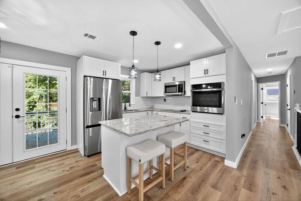 1864 Glen Echo Drive Decatur, GA 30032 - Photo 11 of 38 a kitchen with white cabinets and stainless steel appliances