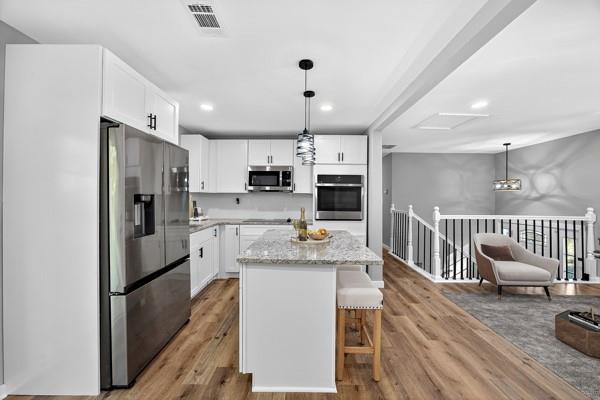 1864 Glen Echo Drive Decatur, GA 30032 - Photo 14 of 38 a open kitchen with stainless steel appliances granite countertop a refrigerator stove microwave and white cabinets