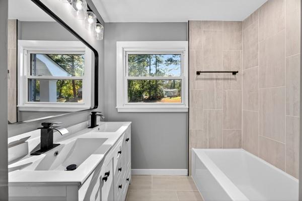1864 Glen Echo Drive Decatur, GA 30032 - Photo 15 of 38 a bathroom with a sink a tub and a window