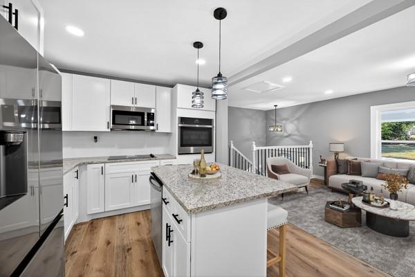 1864 Glen Echo Drive Decatur, GA 30032 - Photo 16 of 38 a kitchen with stainless steel appliances granite countertop a stove top oven a sink dishwasher a dining table and chairs with wooden floor