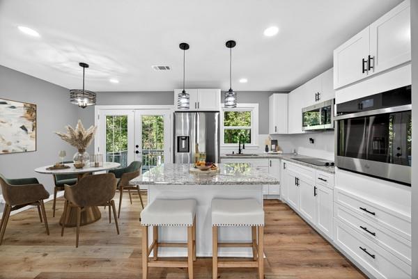 1864 Glen Echo Drive Decatur, GA 30032 - Photo 8 of 38 a kitchen with stainless steel appliances kitchen island granite countertop a table chairs and a stove