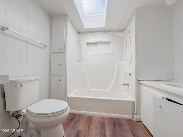 a view of a room with wooden floor and fan