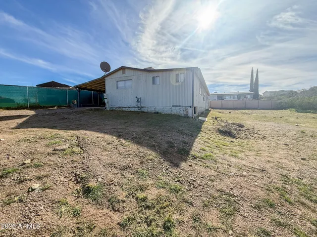 a view of a kitchen with wooden floor and a sink