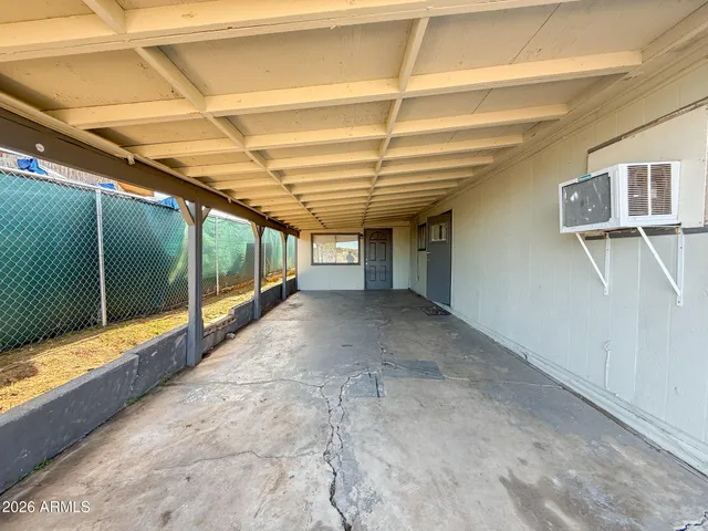 a kitchen with a refrigerator and white cabinets