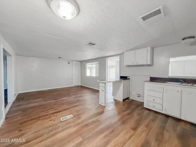 a kitchen with granite countertop a refrigerator and a sink