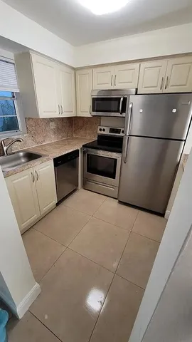 a kitchen with a sink and stainless steel appliances
