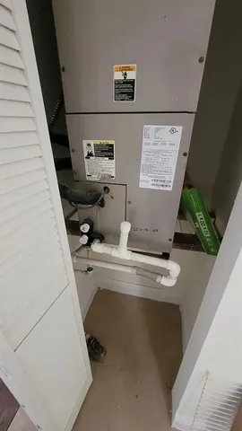 a room with water heater and a potted plant