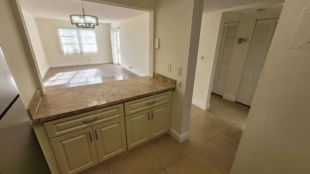 a view of kitchen with granite countertop window