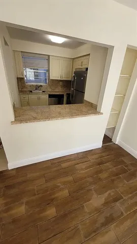 a view of kitchen and wooden floor