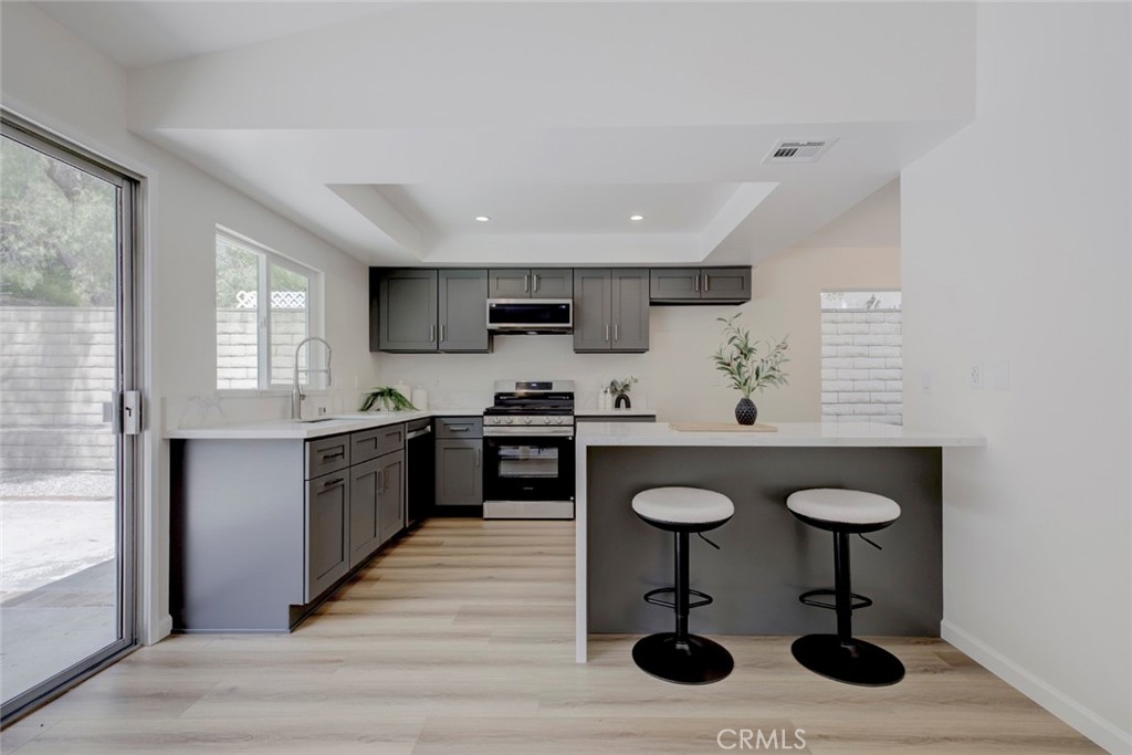 3256 North Frederic Street Burbank, CA 91504 - Photo 13 of 45 a kitchen with granite countertop a sink cabinets and window