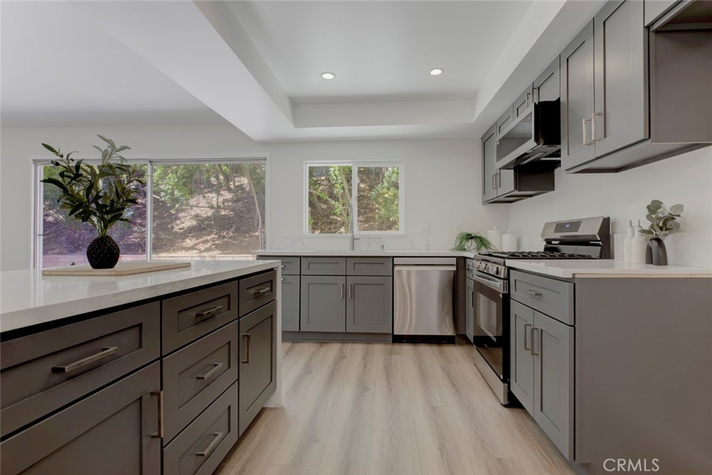 3256 North Frederic Street Burbank, CA 91504 - Photo 16 of 45 a kitchen with a sink stove and cabinets