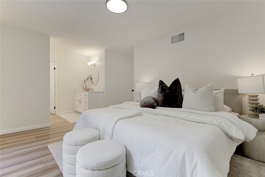 3256 North Frederic Street Burbank, CA 91504 - Photo 24 of 45 a bedroom with a bed and a lamp