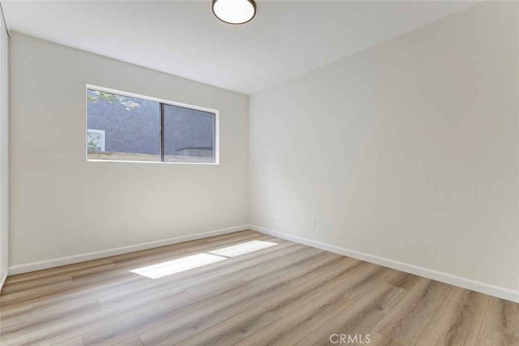 3256 North Frederic Street Burbank, CA 91504 - Photo 30 of 45 a view of an empty room with wooden floor and a window