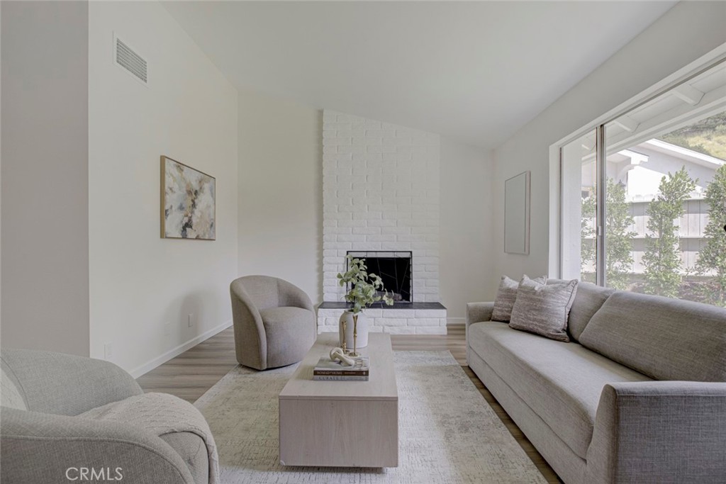3256 North Frederic Street Burbank, CA 91504 - Photo 5 of 45 a living room with furniture and a fireplace