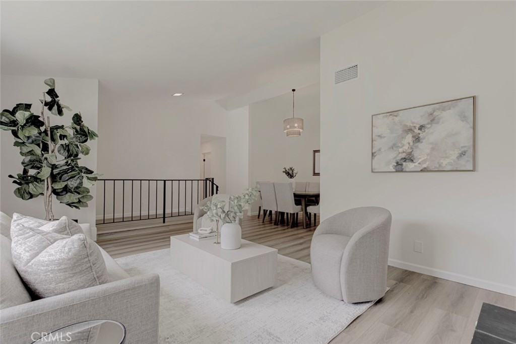 3256 North Frederic Street Burbank, CA 91504 - Photo 6 of 45 a living room with furniture a flower pot and a potted plant