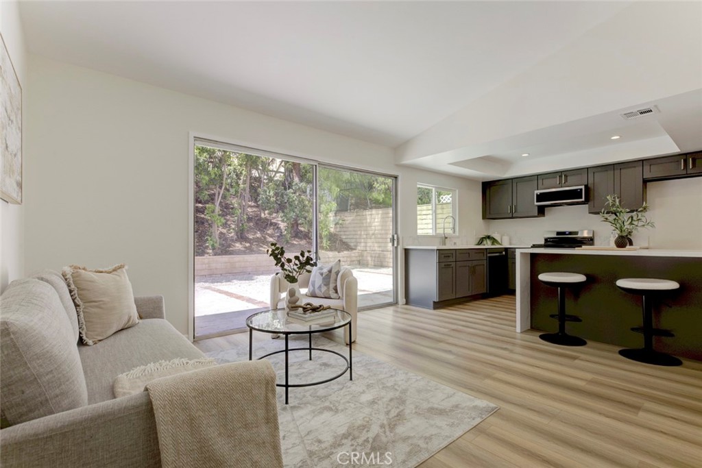 3256 North Frederic Street Burbank, CA 91504 - Photo 10 of 45 a living room with furniture and a wooden floor