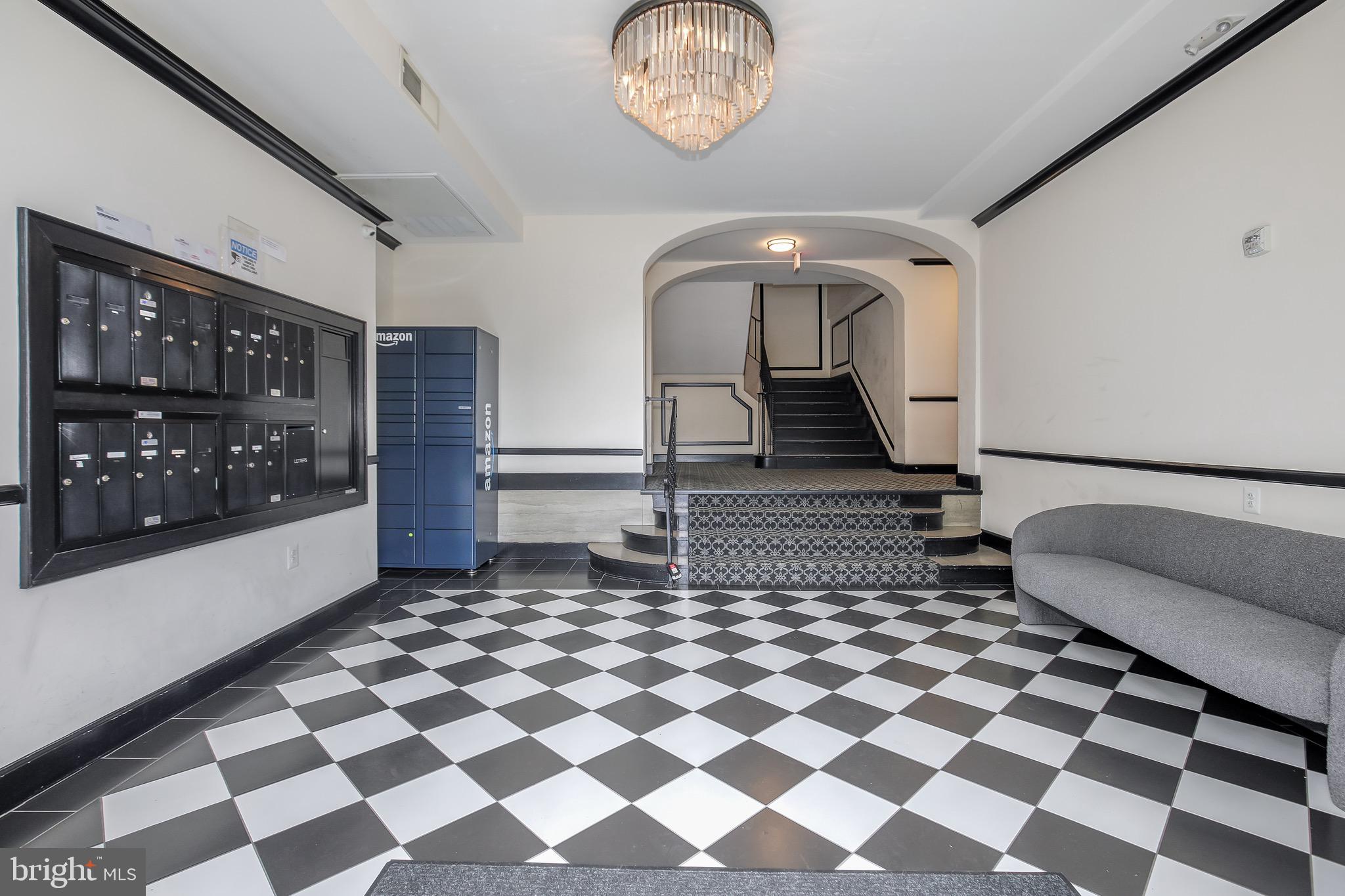 1575 Spring Place Northwest, Unit 35 Washington, DC 20010 - Photo 19 of 22 a living room with a black white checkered floor with couches chair and a coffee table