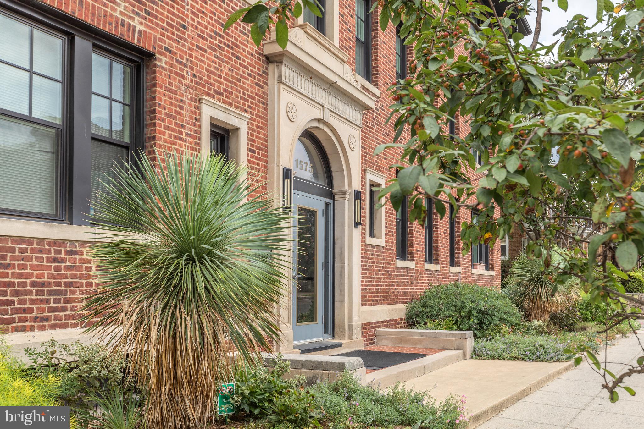 1575 Spring Place Northwest, Unit 35 Washington, DC 20010 - Photo 22 of 22 a front view of a house with a garden