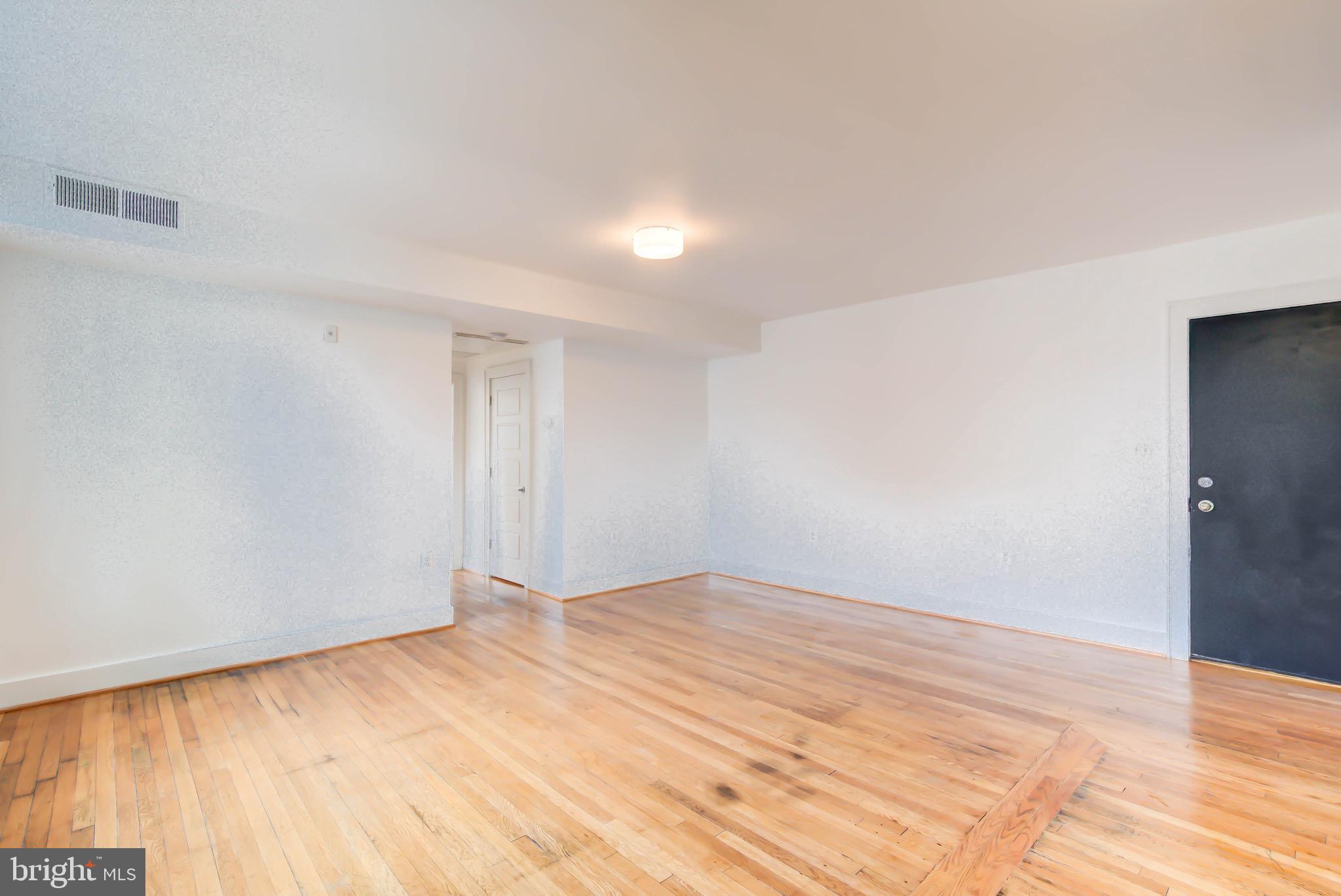 1575 Spring Place Northwest, Unit 35 Washington, DC 20010 - Photo 5 of 22 a view of empty room with wooden floor