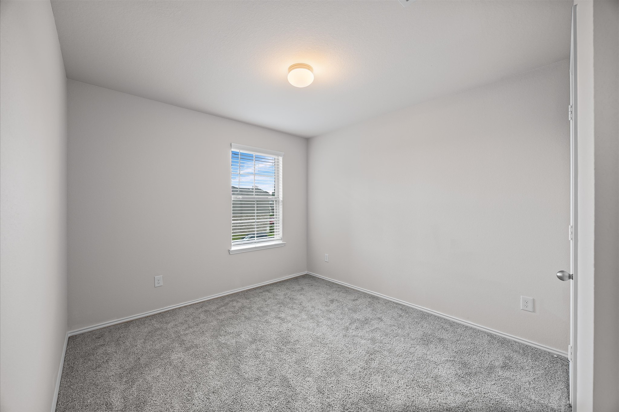 23522 Wedgewood Cliff Way Spring, TX 77373 - Photo 25 of 30 This room features neutral walls, plush carpeting, and a window providing natural light. Ideal for a bedroom or office space.