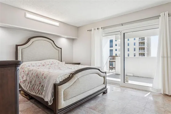 a bedroom with a bed and a mirror