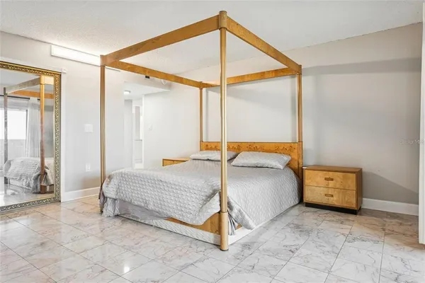 a bedroom with a bed and a chandelier