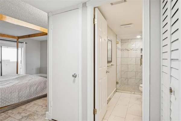 a bathroom with a shower and a glass door