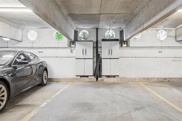 a view of parking garage with cars